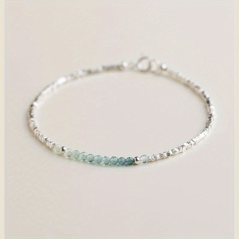 A Delicate Women'S Bracelet Made of 925 Silvery with a Fine Silvery Aquamarine Design, Showcasing a Light Luxury Aesthetic And a Unique Broken Style