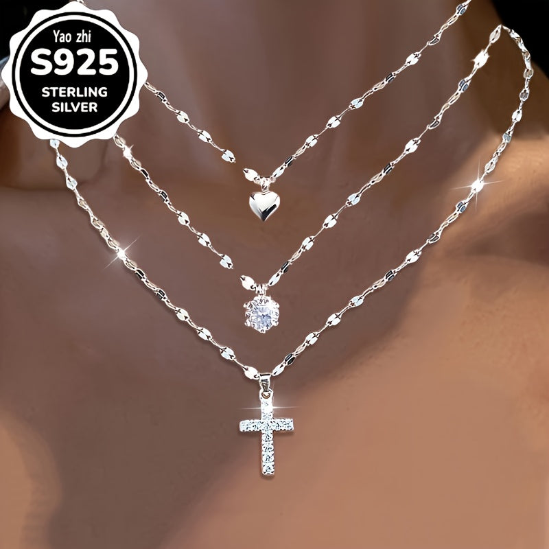 This Collection Features Three Stylish Lip Cross Necklaces Made of 925 Sterling Silver, Adorned with Shimmering Synthetic Cubic Zirconia And a Heart-Shaped Charm. The Exquisite Coconut Snowflake Chain Complements The Cubic Zirconia Necklace