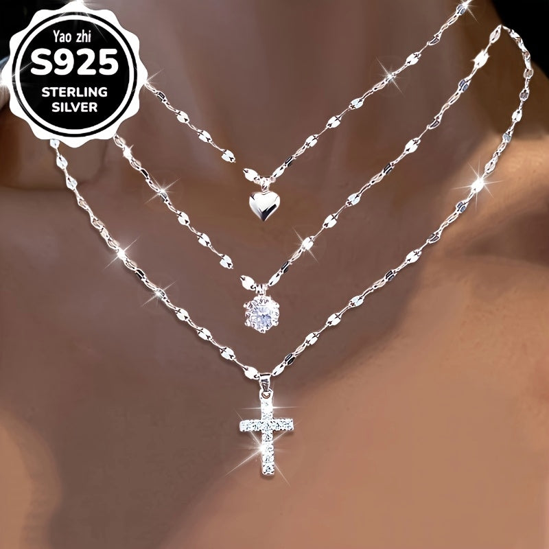 This Collection Features Three Stylish Lip Cross Necklaces Made of 925 Sterling Silver, Adorned with Shimmering Synthetic Cubic Zirconia And a Heart-Shaped Charm. The Exquisite Coconut Snowflake Chain Complements The Cubic Zirconia Necklace