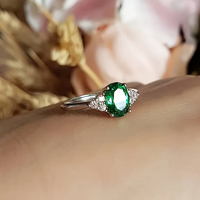 An elegant S925 sterling Silvery ring adorned with vibrant green oval shaped synthetic Synthetic Zirconia, perfect for weddings or grand events - an eternal gift for her anniversary