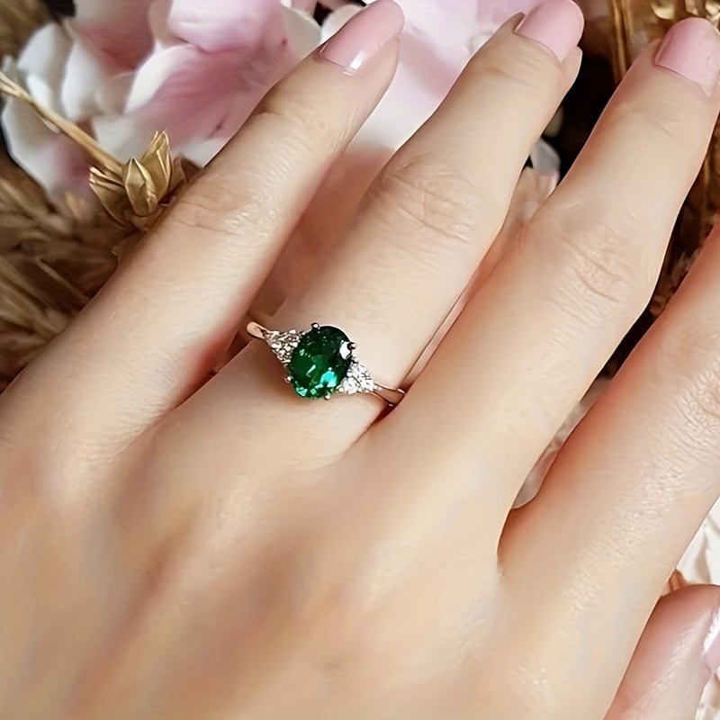 An elegant S925 sterling Silvery ring adorned with vibrant green oval shaped synthetic Synthetic Zirconia, perfect for weddings or grand events - an eternal gift for her anniversary