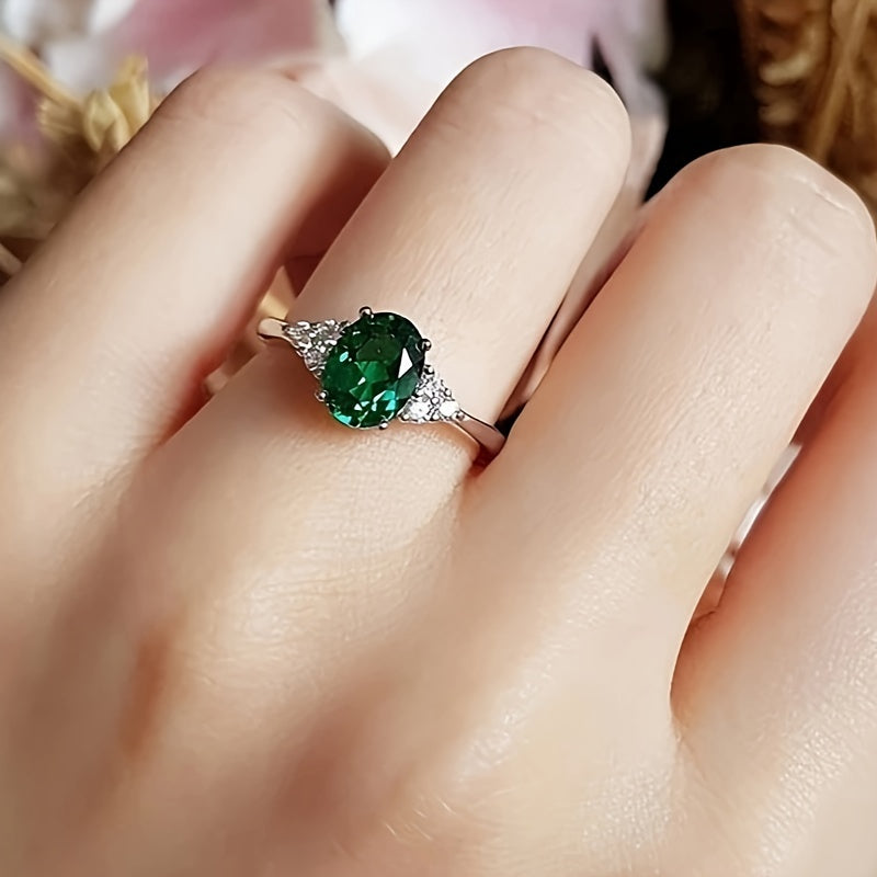 An elegant S925 sterling Silvery ring adorned with vibrant green oval shaped synthetic Synthetic Zirconia, perfect for weddings or grand events - an eternal gift for her anniversary